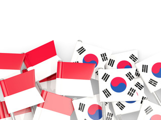 Pins with flags of Indonesia and south korea isolated on white.
