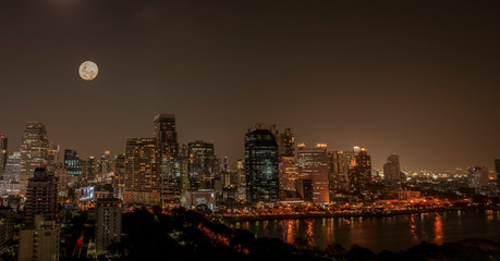 Full Moon over Bangkok Skyline on a Clear Night