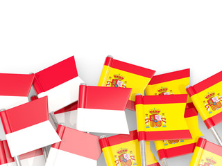 Pins with flags of Indonesia and spain isolated on white.