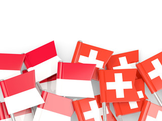Pins with flags of Indonesia and switzerland isolated on white.