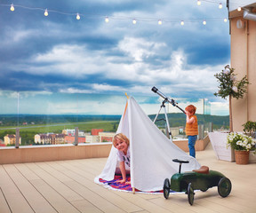 cute happy kids playing games on the rooftop patio