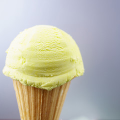 Ice-cream scoop in waffle ice cream cone with copy space. Summer background, vacation, refreshment, traditional seasonal cold sweets