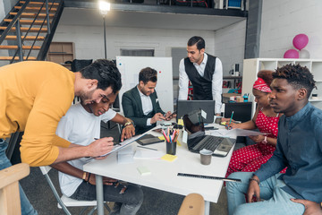 A group of young people leads a discussion, sitting in the office.