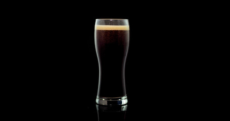 Craft beer brewed from natural malt and barley in a private brewery on a black background
