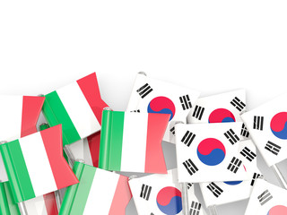 Pins with flags of Italy and south korea isolated on white.
