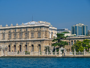 Naklejka premium Dolmabahce palace exterior and modern builings view from sea. Istanbul, Turkey.