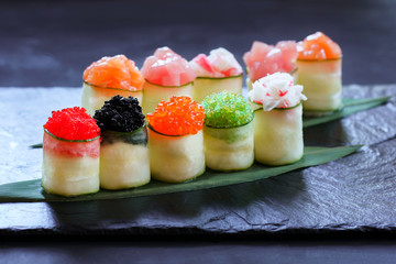 Seafood delicatessen sushi rolls on slate. Different gourmet snacks. Luxury lifestyle, Japanese food art, expensive meals, restaurant menu