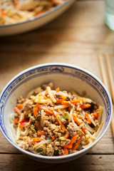Chinese pork noodle stir fry with egg noodles and vegetables in bowl 