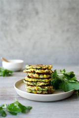 Zucchini fritters or vegetarian zucchini pancakes with yogurt sauce. Vegetarian food
