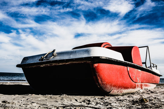 Vintage italian "pedal&ograve;", paddle bpat from the Seventies, abondoned in a Riviera Romagnola beach.