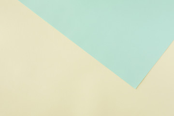 Green and yellow pastel paper color for background, top view