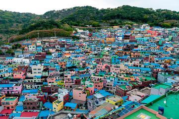 Scenic landscape of Gamcheon Culture Village, colorful and artistic tourist attraction with brightly painted houses on hillside of coastal mountain in Saha District, Busan, South Korea