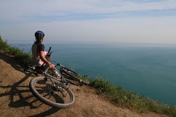 Cyclist admires the view of the Black sea, Russia.