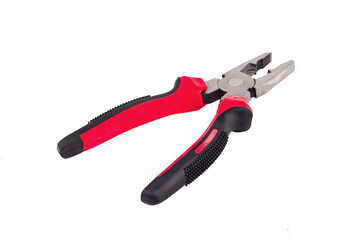One new metal pliers with rubber handles black and red color isolated on white background. Repair or building concept