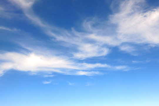 the bright blue sky background with some white cloud © Supattra