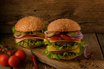 Home cooking burgers  on a dark wooden background.