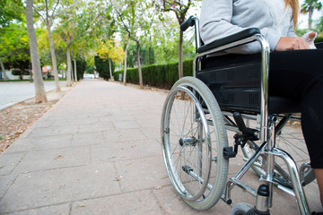 Wheelchair on the outside, in a park on a brick floor
