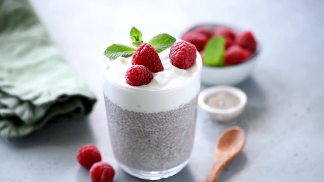 Chia pudding parfait with raspberries and greek yogurt in glass. Healthy food, vegetarian diet