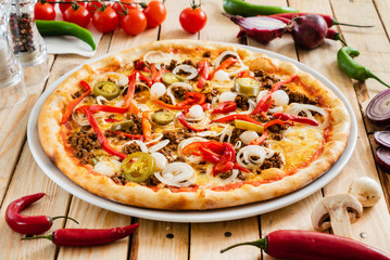 tasty pizza on the wooden background