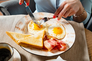 woman having traditional breakfast in the cafe