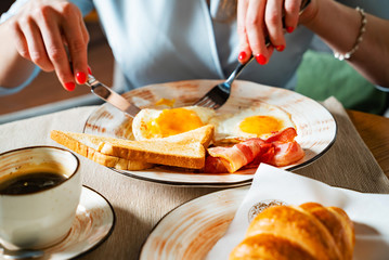 woman having traditional breakfast in the cafe