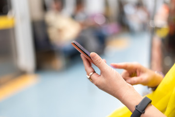 using smartphone at the MRT carriage