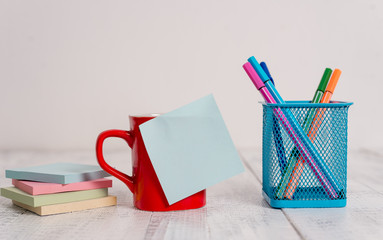 Coffee cup blank sticky note pens metal holder stacked pads wooden table