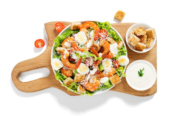 Caesar Salad with Shrimp served with croutons,caesar sauce and parmesan. isolated on white background.