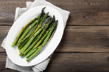Grilled green asparagus on white plate. top wiew