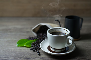 Coffee Time, Fresh black coffee on wooden table, Coffee beans in sacks, cups and kettles, Close-up, Copy-space.