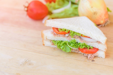 sandwich tuna salad with the ingredients on wood plate