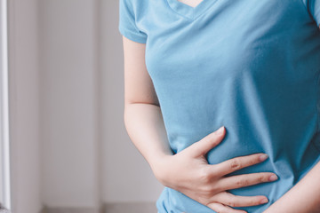 Young woman suffering from abdominal pain.Menstrual pain.