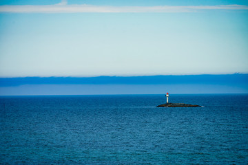 Obraz premium Seascape sandy beach with lighthouse on horizon