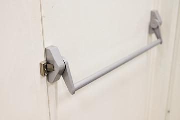 Handle for opening white metal doors.