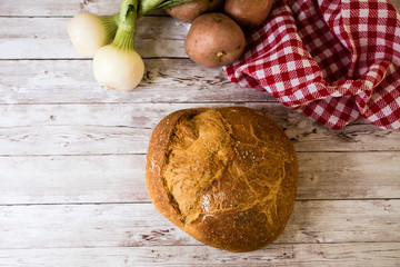 freshly baked bread on wooden kitchen table, top view