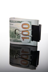 Isolated pile of dollars in the money clip