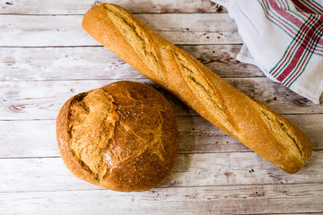 freshly baked bread on wooden kitchen table, top view