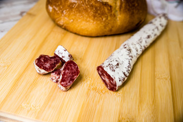 slices of spanish fuet on table with bread
