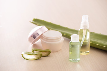 Obraz na płótnie Canvas Jar of cream with aloe vera and shower gel or infusion with aloe leave isolated on light background