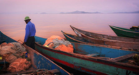 Colorful scenic sunset with fishing boats in the foreground on Mfangano Island, Lake Victoria, Kenya