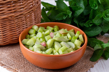 Frozen rhubarb in a plate on a white wooden table