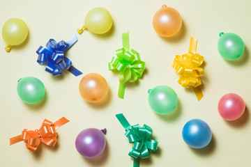 Happy holiday frame background with colorful balloon, gifts, confetti, carnival cap and streamer. Flat lay. Top view. Birthday or party card with copy space.