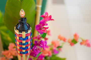 An oil lamp or pelita with bamboo holder for Eid ul fitr decoration.