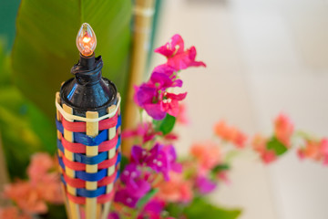 An oil lamp or pelita with bamboo holder for Eid ul fitr decoration.
