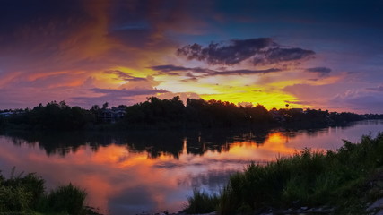 sunset at Mae Klong river, beautiful rever view evening of cloudy sky painted with vivid sun light in the sky background, Ban Pong City, Ratchaburi, Thailand.