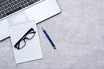 Top view Office desktop with office accessories, Desktop with notebook and glasses and note with pen. Contains empty space for your design or installation. Business and work concept.