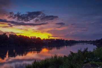 sunset at Mae Klong river, beautiful rever view evening of cloudy sky painted with vivid sun light in the sky background, Ban Pong City, Ratchaburi, Thailand.