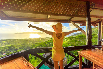 Carefree lifestyle female enjoying spectacular views of Seychelles and Indian Ocean at sunset...
