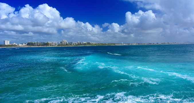 Beautiful weather at Buddina Beach along Pacific Boulevard (Sunshine Coast, Queensland, Australia). Big waves. Mooloolaba in the background.