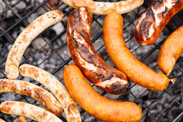the process of cooking sausages or sausages on the grill